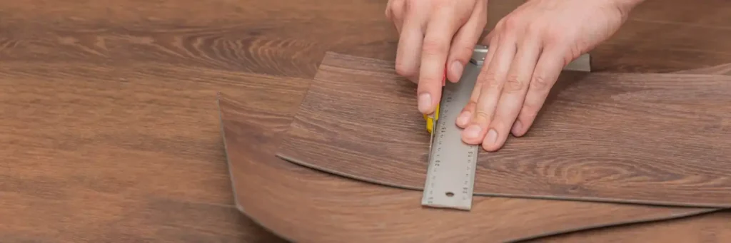 flooring contractor cutting vinyl plank